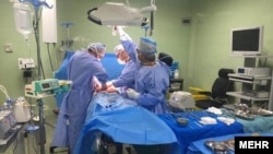 Doctors in a hospital in Iran operating on a patient